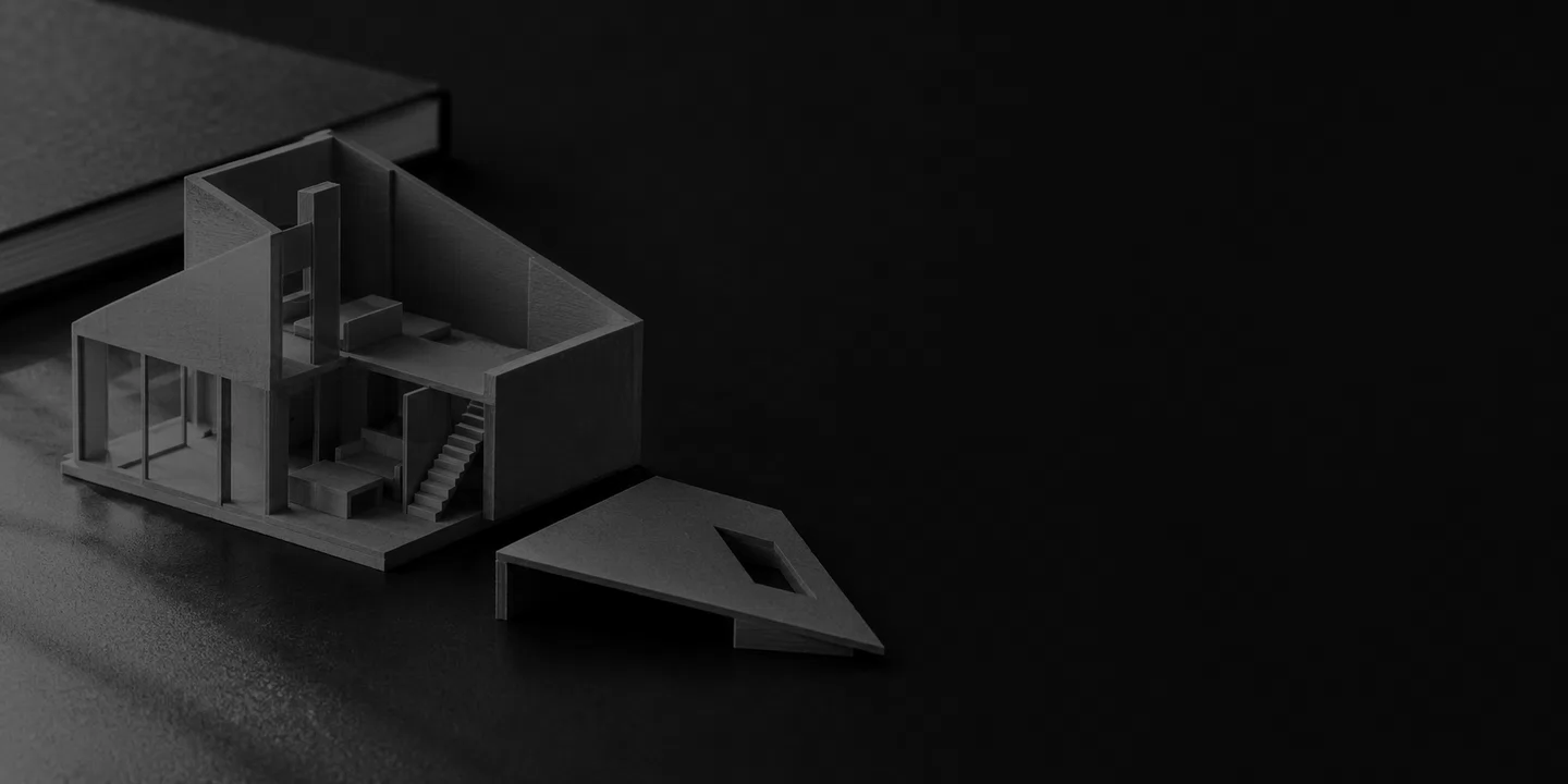 Greyscale conceptual architectural study model with a detached roof panel and a closed sketchbook on a dark desk.
